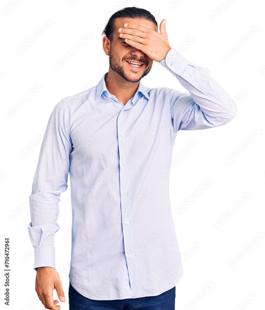 Young handsome man wearing business clothes smiling and laughing with hand on face covering eyes for surprise. blind concept. Young handsome man wearing business clothes smiling and laughing with hand on face covering eyes for surprise. blind concept.