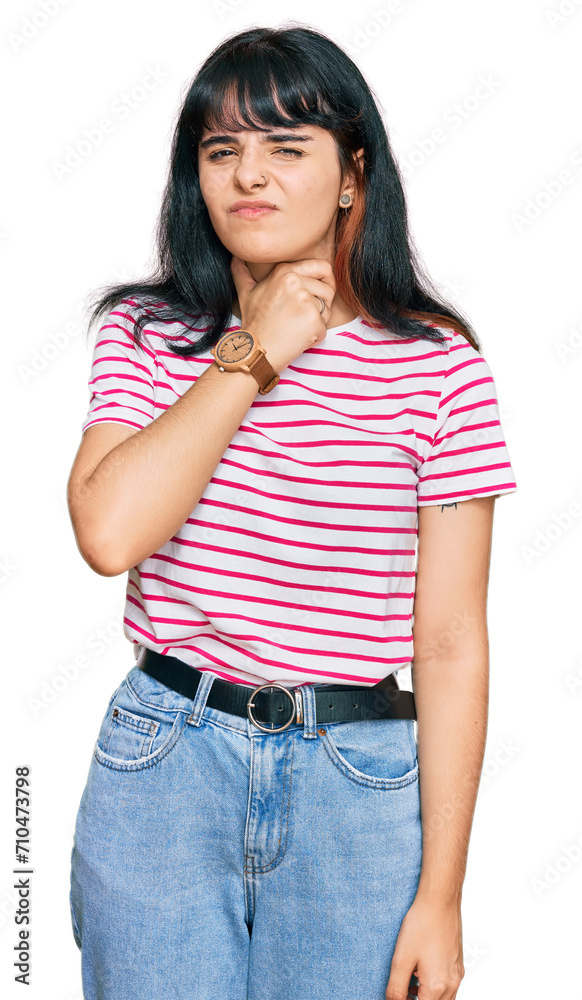 Young hispanic girl wearing casual clothes touching painful neck, sore throat for flu, clod and infection Young hispanic girl wearing casual clothes touching painful neck, sore throat for flu, clod and infection