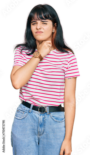 Young hispanic girl wearing casual clothes touching painful neck, sore throat for flu, clod and infection