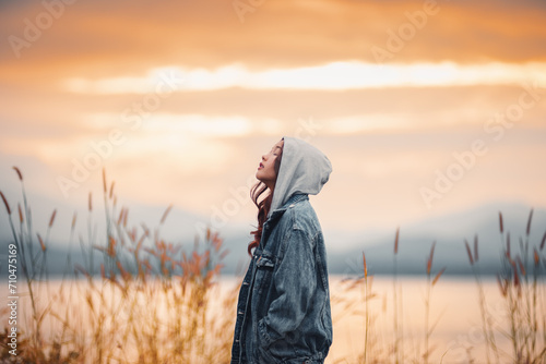 Woman with sunset light reflecting on water