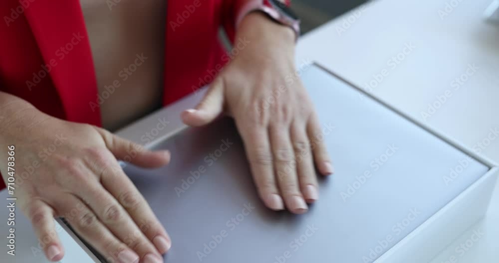Minsk, Belarus, November 23, 2021: Woman woman takes new one out of box of Apple Macbook Air. Applications for App Store in iTunes