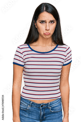 Young hispanic girl wearing casual striped t shirt depressed and worry for distress, crying angry and afraid. sad expression.