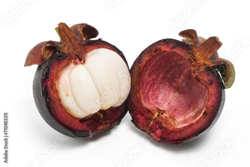 Half cut sliced fresh organic mangosteen delicious fruit with peel isolated on white background clipping path