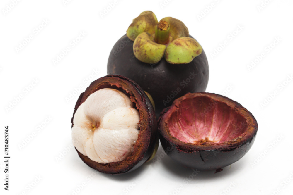 Fototapeta premium Half cut sliced and whole fresh organic mangosteen delicious fruit with peel isolated on white background clipping path