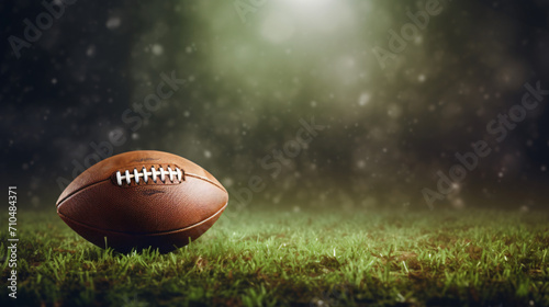 Leather American football ball on green grass. Space