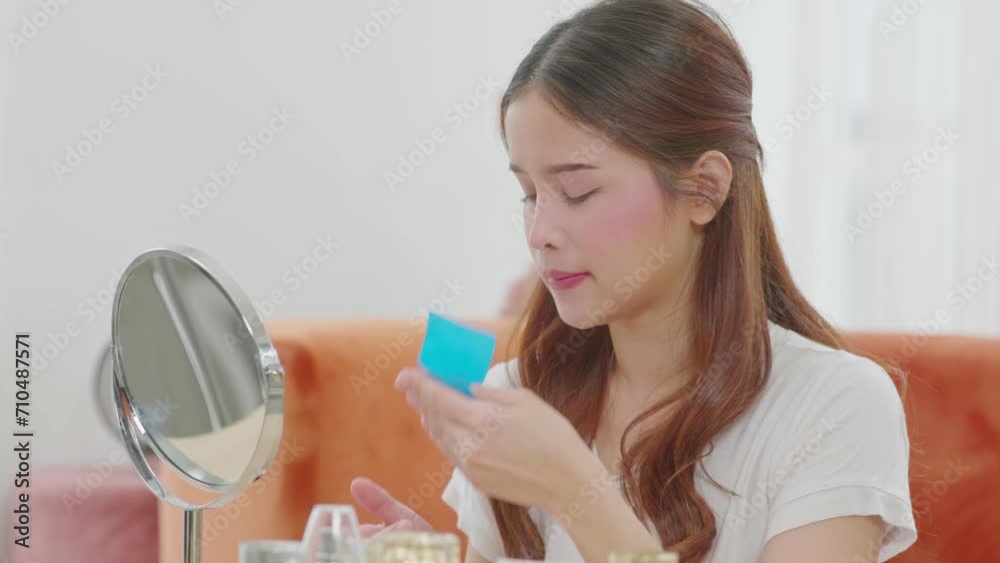 Asian young woman looking in mirror doing skin care touch cheek using oil film worry about oily face and beauty treatment at home,Wellness woman self care with beauty product at home Asian young woman looking in mirror doing skin care touch cheek using oil film worry about oily face and beauty treatment at home,Wellness woman self care with beauty product at home
