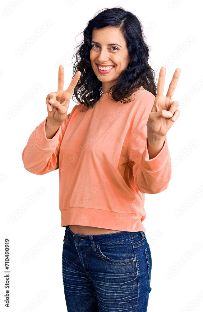 Young beautiful hispanic woman wearing casual clothes smiling looking to the camera showing fingers doing victory sign. number two. Young beautiful hispanic woman wearing casual clothes smiling looking to the camera showing fingers doing victory sign. number two.