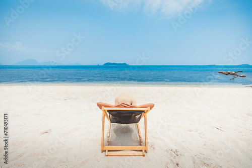 Happy traveler asian woman relax and travel on chair beach in summer Thailand