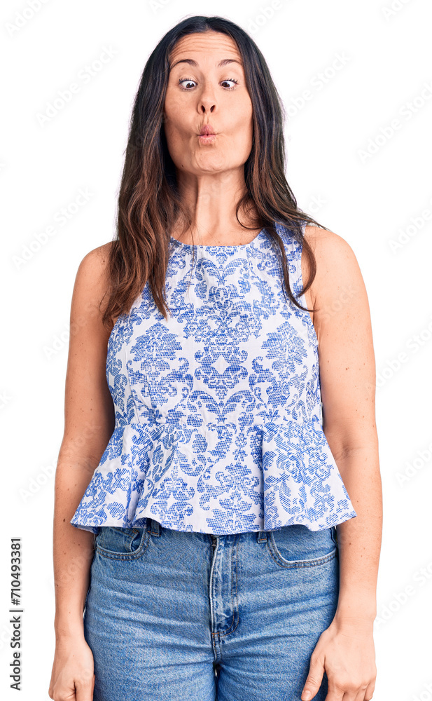 Young beautiful brunette woman wearing casual t-shirt making fish face with lips, crazy and comical gesture. funny expression. Young beautiful brunette woman wearing casual t-shirt making fish face with lips, crazy and comical gesture. funny expression.
