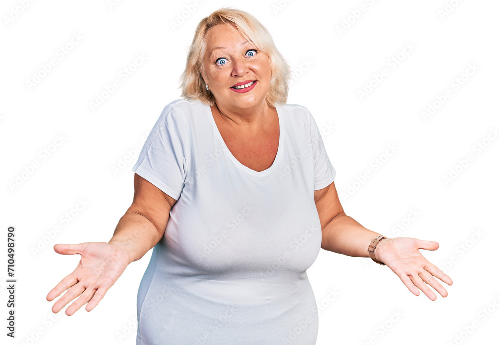 Middle age blonde woman wearing casual white t shirt smiling cheerful with open arms as friendly welcome, positive and confident greetings Middle age blonde woman wearing casual white t shirt smiling cheerful with open arms as friendly welcome, positive and confident greetings