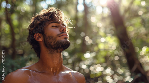 Portrait of handsome man with closed eyes looking away in the forest