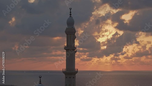 Minaret at cloudy sunset (Al-Hasayna mosque at Gaza City, 2021) photo