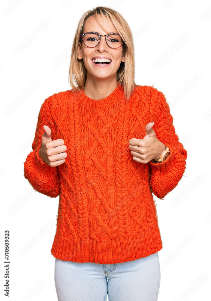 Obraz premium Beautiful blonde woman wearing casual clothes and glasses success sign doing positive gesture with hand, thumbs up smiling and happy. cheerful expression and winner gesture.