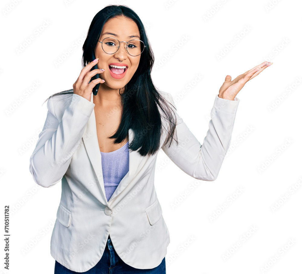 Beautiful hispanic woman with nose piercing having conversation talking on the smartphone celebrating victory with happy smile and winner expression with raised hands Beautiful hispanic woman with nose piercing having conversation talking on the smartphone celebrating victory with happy smile and winner expression with raised hands