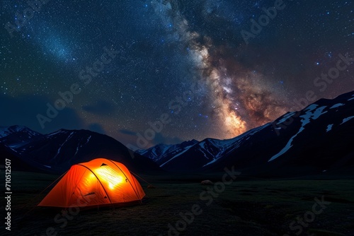 Starry Night Camping in Mountains. Orange tent glowing under Milky Way.