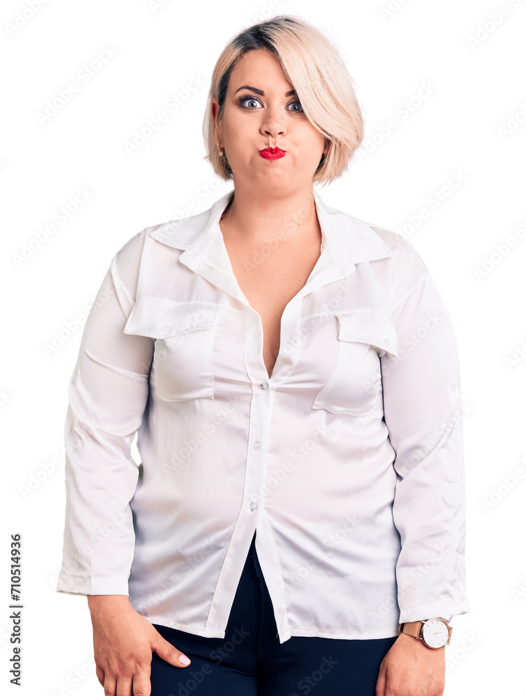 Young blonde plus size woman wearing casual shirt puffing cheeks with funny face. mouth inflated with air, crazy expression. Young blonde plus size woman wearing casual shirt puffing cheeks with funny face. mouth inflated with air, crazy expression.