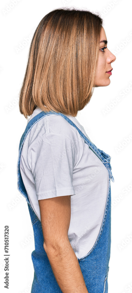 Young blonde girl wearing casual clothes looking to side, relax profile pose with natural face with confident smile. Young blonde girl wearing casual clothes looking to side, relax profile pose with natural face with confident smile.