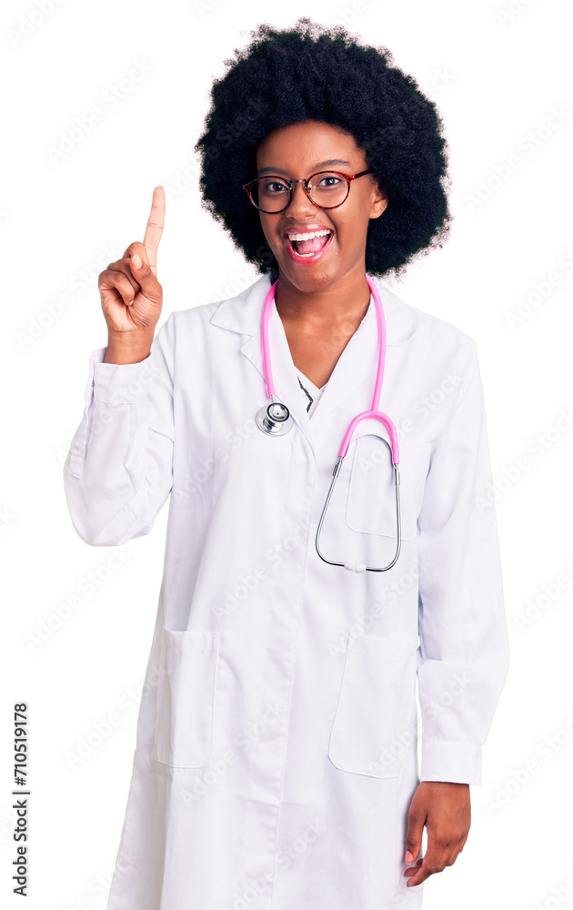 Young african american woman wearing doctor coat and stethoscope pointing finger up with successful idea. exited and happy. number one. Young african american woman wearing doctor coat and stethoscope pointing finger up with successful idea. exited and happy. number one.