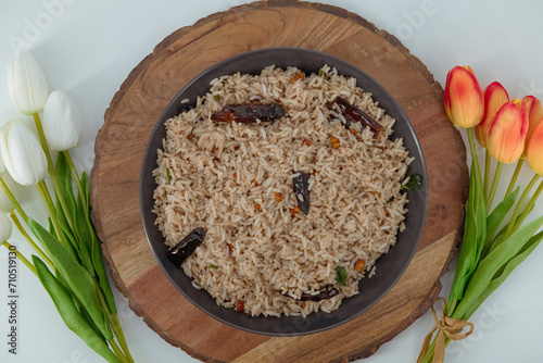 Tamarind Rice/  Puliyodharai / Puliyogare - Tangy and spicy South Indian rice dish as break fast , Lunch or dinner isolated in white background. Tamarind as main ingredient and other spices.  photo