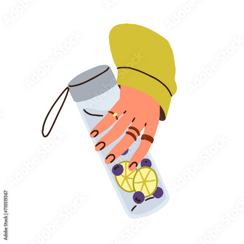 Hand taking own glass bottle, water infused with fresh fruits, berries. Hold ...