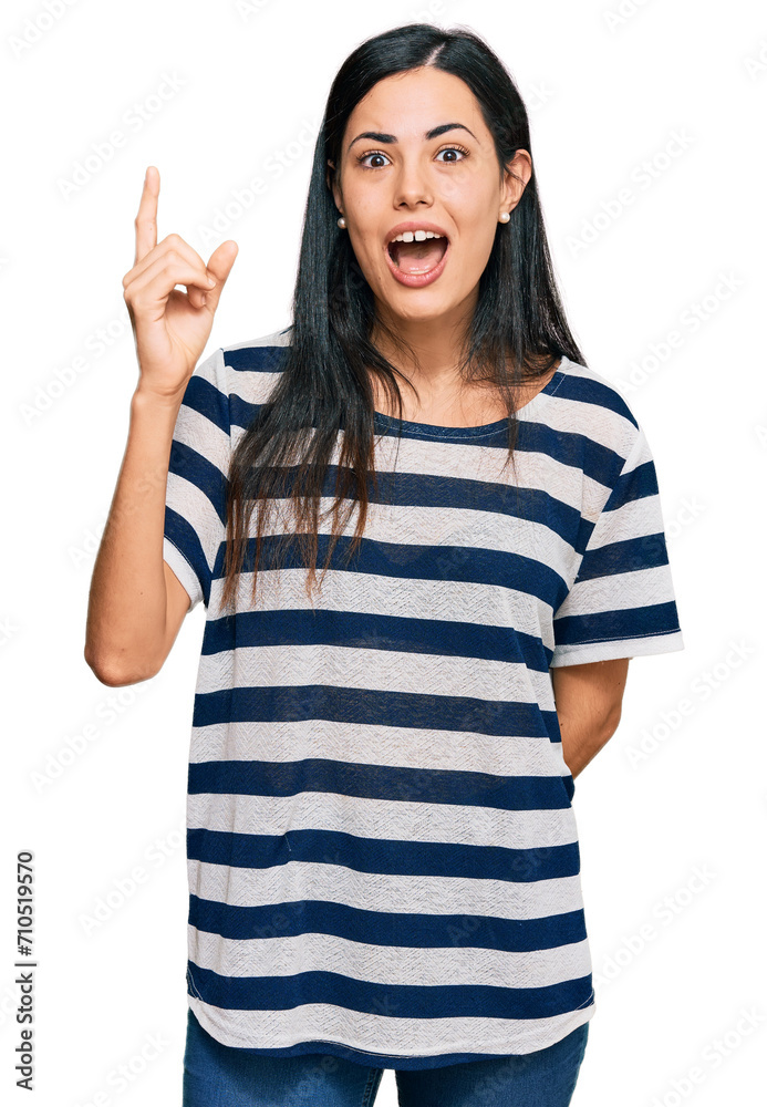 Beautiful young woman wearing casual clothes pointing finger up with successful idea. exited and happy. number one. Beautiful young woman wearing casual clothes pointing finger up with successful idea. exited and happy. number one.