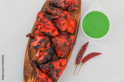 Arabian spicy food concept - homemade tandoori. Arabian ,Arabic cuisine- grilled ,tandoori chicken. Tandoori chicken - prepared by roasting chicken marinated in yoghurt and spices in a tandoor. photo