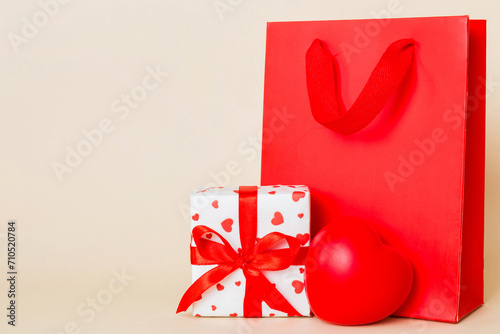 Shopping bag with gift box on colored background perspecrive view. Space for text holiday concept