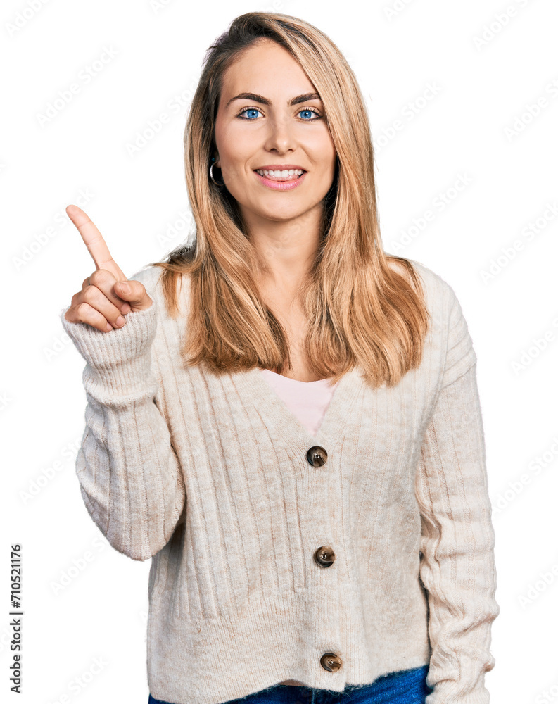 Young blonde woman wearing casual clothes pointing finger up with successful idea. exited and happy. number one. Young blonde woman wearing casual clothes pointing finger up with successful idea. exited and happy. number one.