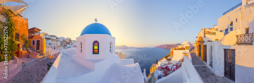 View of Oia at sunset, a small town with whitewashed houses on Santorini Island, Cyclades islands archipelagos, Aegean Sea, Greece. photo