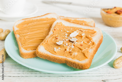 Peanut butter sandwiches or toasts on light table background.Breakfast. Vegetarian food. American cuisine top view vith copy space