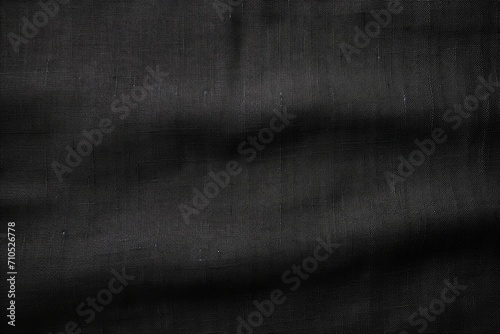 Black organic fabric bag pattern on linen background.