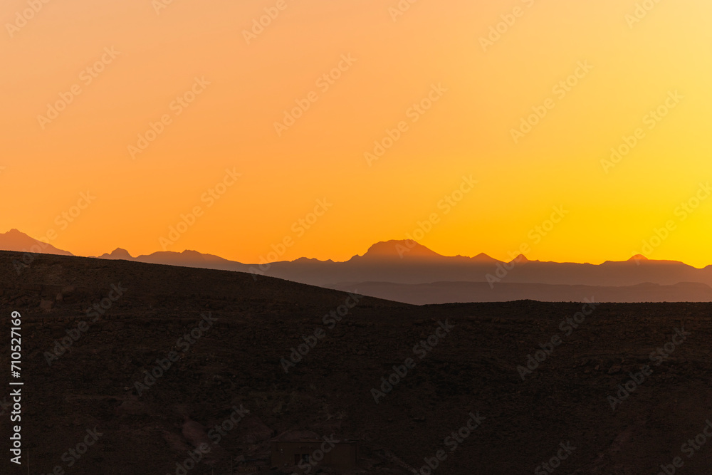 View of the valley and the canyon on the High Atlas mountain range at sunset near Ait Benhaddou, Ouarzazate, Central Morocco. View of the valley and the canyon on the High Atlas mountain range at sunset near Ait Benhaddou, Ouarzazate, Central Morocco.