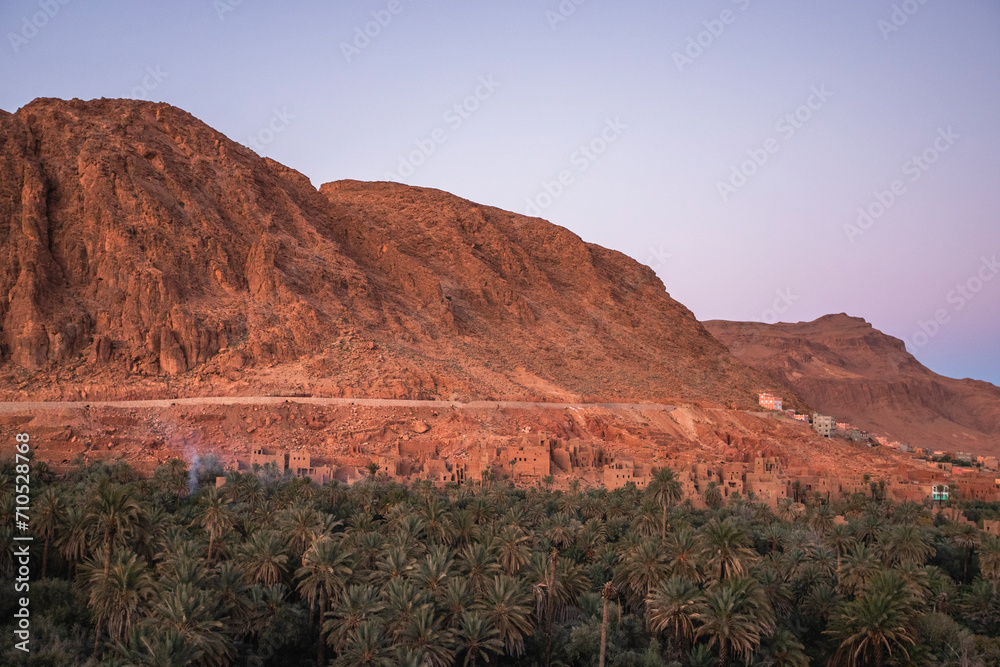View of the Palmeraie de Tinghir, a valley with palm trees near Ait Ismene village at sunset, Tinghir, Morocco. View of the Palmeraie de Tinghir, a valley with palm trees near Ait Ismene village at sunset, Tinghir, Morocco.
