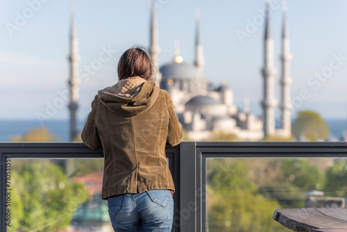 View of a person looking at Sultanahmet Camii (the Blue Mosque) in Sultanahmet district along the Bosphorus strait, European side of Istanbul, Turkey. photo