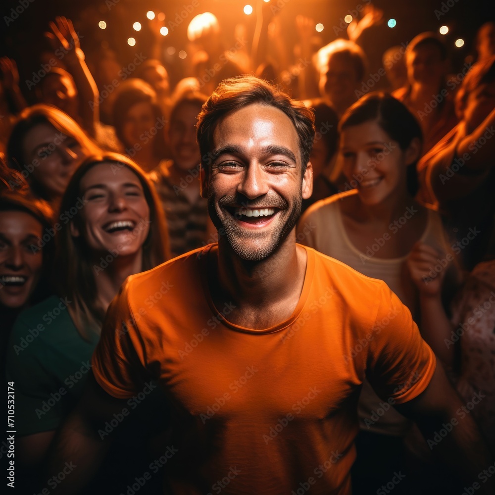Man Smiling in Front of a Crowd of People