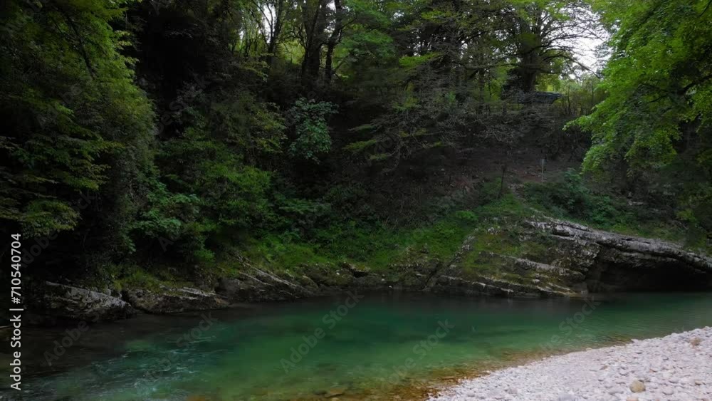 a mountain river with clear water among green trees. the stones are turned by the stream. Tourist place for rest and swimming. Aerial view. western Georgia, Abasha river Martvili a mountain river with clear water among green trees. the stones are turned by the stream. Tourist place for rest and swimming. Aerial view. western Georgia, Abasha river Martvili