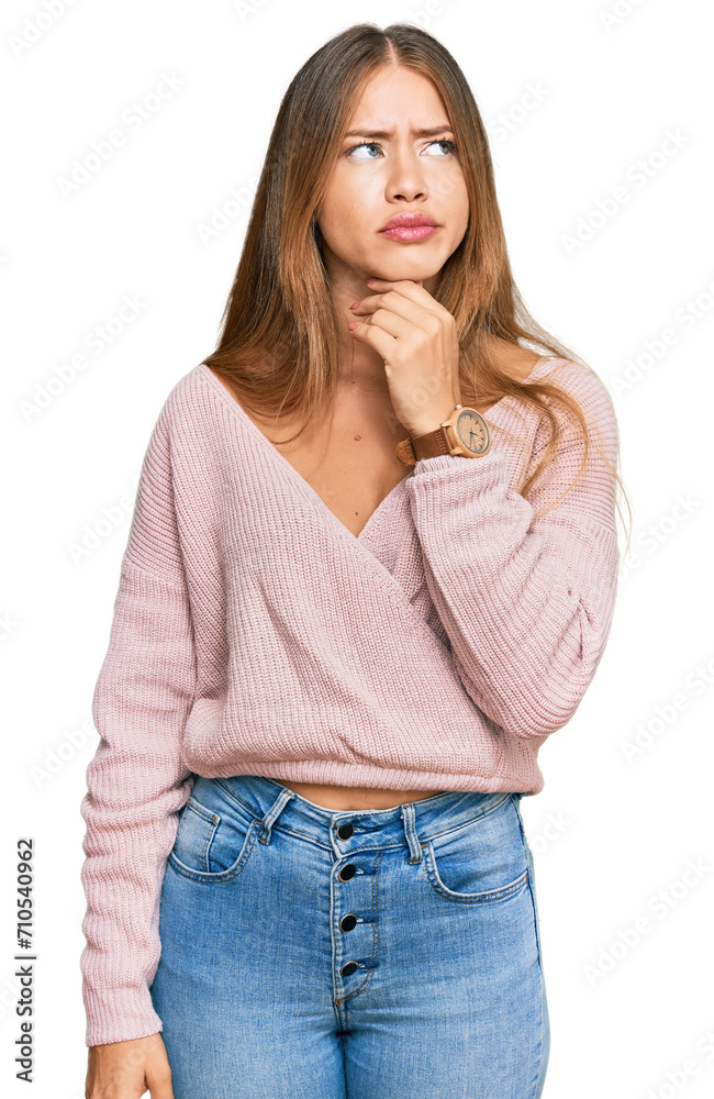 Beautiful blonde woman wearing casual winter pink sweater touching painful neck, sore throat for flu, clod and infection Beautiful blonde woman wearing casual winter pink sweater touching painful neck, sore throat for flu, clod and infection