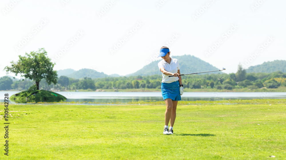 Golfer sport course golf ball fairway. People lifestyle woman relax after swing golf ball on the green. Asia female player game shot in summer. Healthy and Sport outdoor, copy space for text Golfer sport course golf ball fairway. People lifestyle woman relax after swing golf ball on the green. Asia female player game shot in summer. Healthy and Sport outdoor, copy space for text