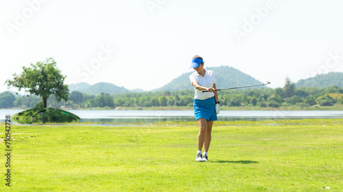 Golfer sport course golf ball fairway. People lifestyle woman relax after swing golf ball on the green. Asia female player game shot in summer. Healthy and Sport outdoor, copy space for text
