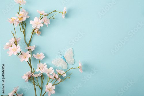 Blue spring paper background and pink flowers