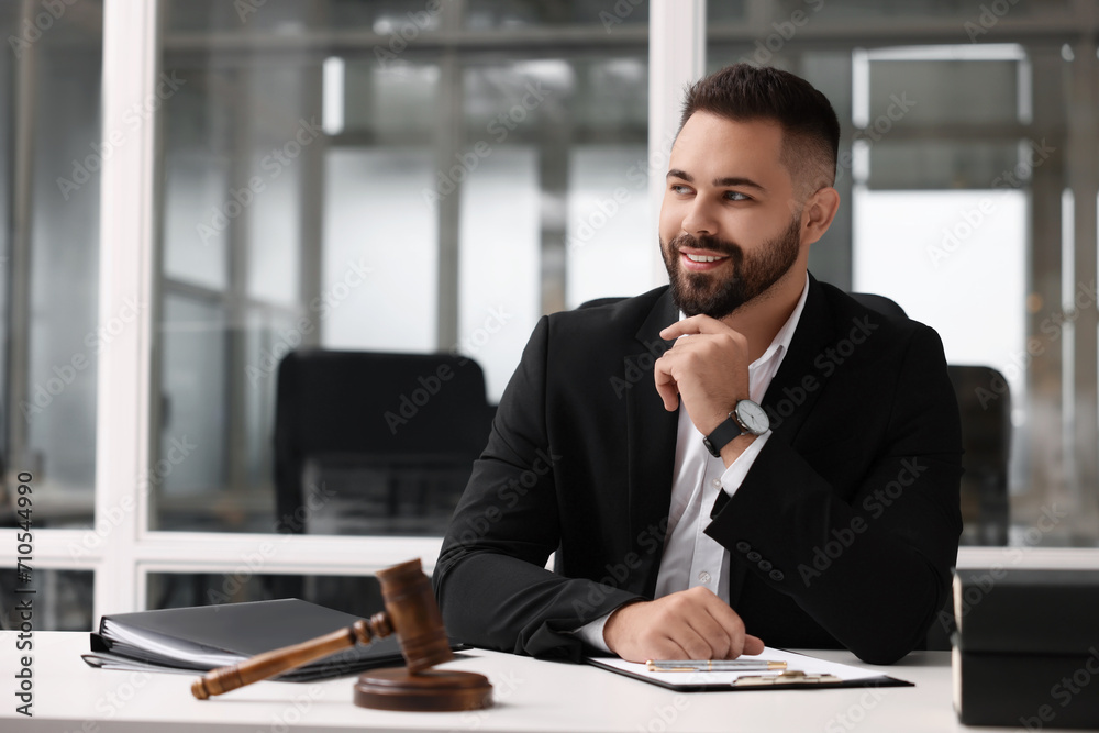 Portrait of smiling lawyer at table in office Portrait of smiling lawyer at table in office