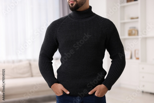 Man in stylish sweater at home, closeup