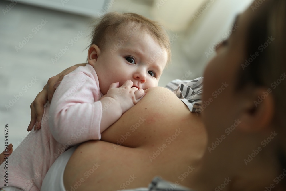 Young woman breastfeeding her baby at home, closeup Young woman breastfeeding her baby at home, closeup