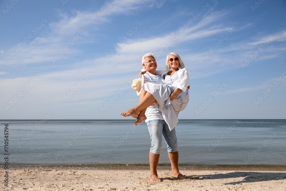 Mature couple spending time together on sea beach Mature couple spending time together on sea beach