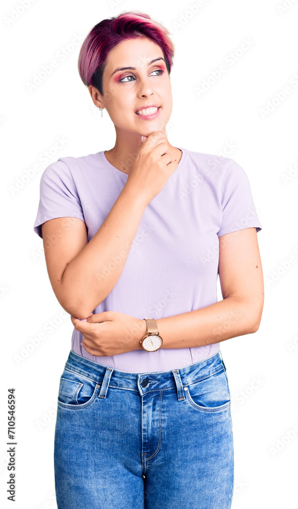 Young beautiful woman with pink hair wearing casual clothes with hand on chin thinking about question, pensive expression. smiling with thoughtful face. doubt concept. Young beautiful woman with pink hair wearing casual clothes with hand on chin thinking about question, pensive expression. smiling with thoughtful face. doubt concept.