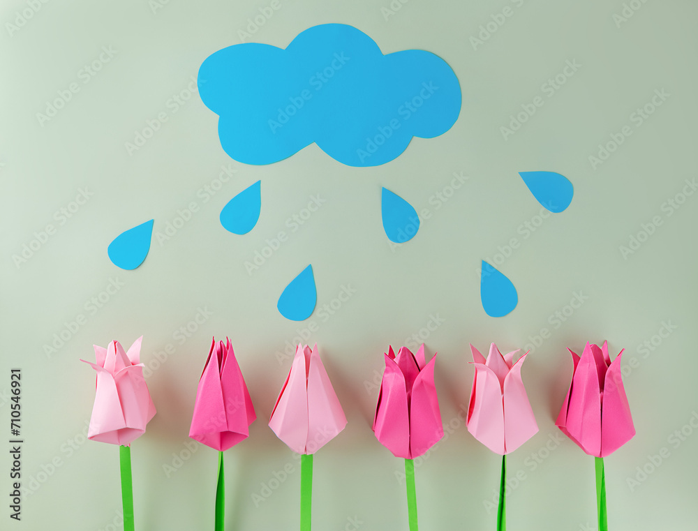 Tulips with cloud and rain made of colored paper on a green background, handmade, craft, applique. Mother's day, women's day concept.