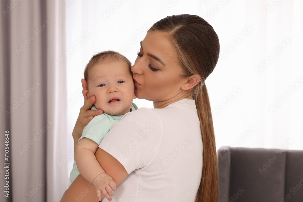 Mother holding her cute newborn baby at home Mother holding her cute newborn baby at home