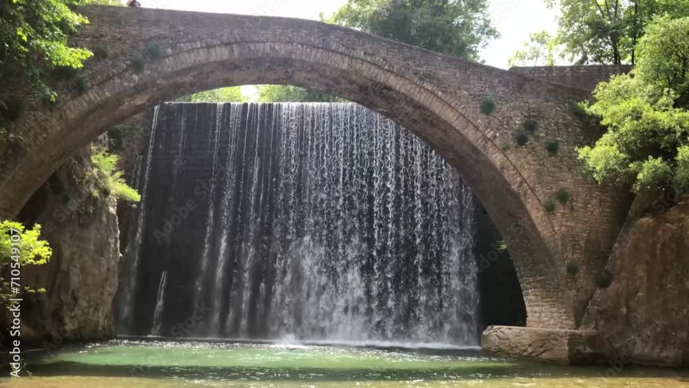The old stone, arched bridge, between two waterfalls in Palaiokaria, Trikala prefecture, Thessaly, Greece.