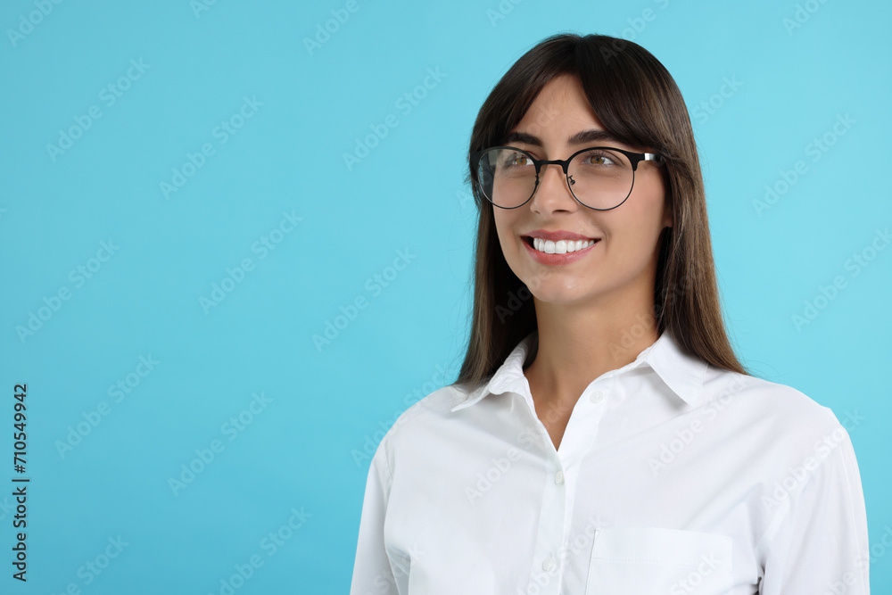 Portrait of happy secretary on light blue background. Space for text Portrait of happy secretary on light blue background. Space for text