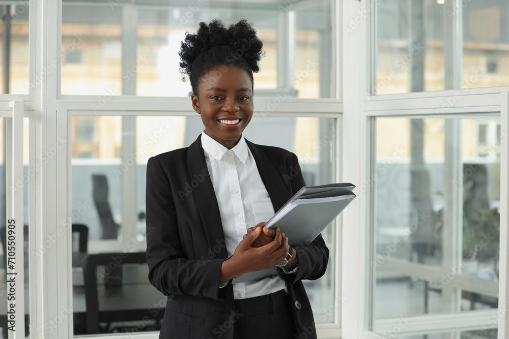 Fototapeta premium Happy woman with folders in office. Lawyer, businesswoman, accountant or manager